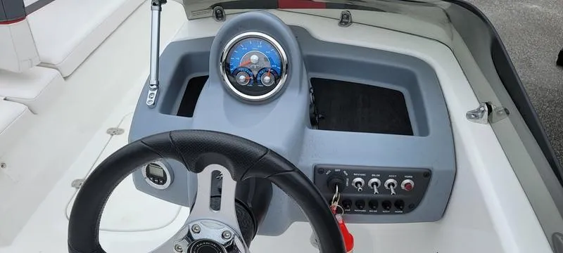 Slide: The Image of 2022 Tahoe T16 boat dashboard with steering wheel and control panel. - 8