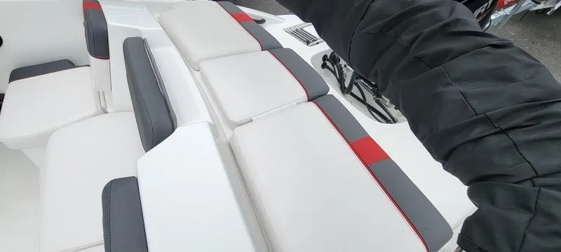 Slide: The Image of 2022 Tahoe T16 boat interior with white, gray, and red cushioned seating. - 9