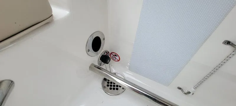 Slide: The Image of 2021 Robalo R200 boat interior with drain and safety features. - 12