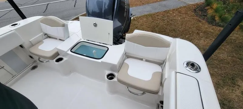 Slide: The Image of 2021 Robalo R200 boat interior with seating and storage compartments. - 16