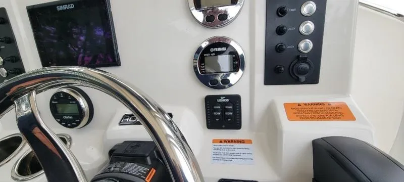 Slide: The Image of 2021 Robalo R200 boat dashboard with steering wheel and control panel. - 17