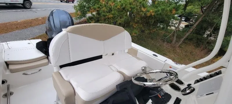 Slide: The Image of 2021 Robalo R200 boat interior with steering wheel and seating. - 18