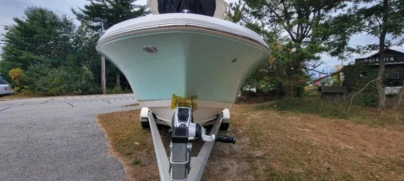 Slide: The Image of 2021 Robalo R200 boat on trailer, parked on grass near road. - 19