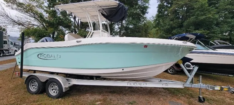 Slide: The Image of 2021 Robalo R200 boat on trailer, light blue hull, parked outdoors. - 21