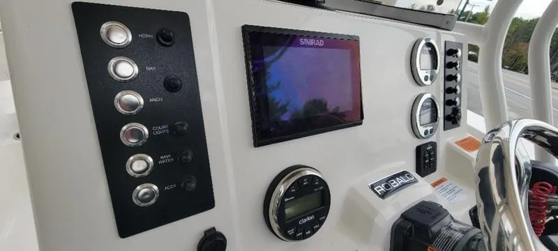 Slide: The Image of Dashboard of 2021 Robalo R200 boat with controls and navigation display. - 22
