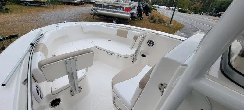 Slide: The Image of 2021 Robalo R200 boat interior with white seating and spacious deck. - 23