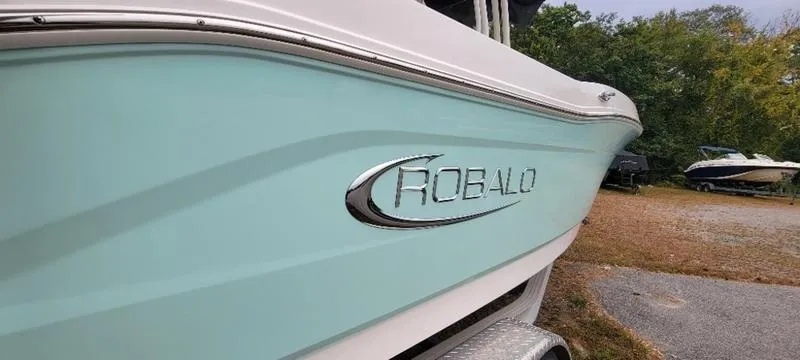 Slide: The Image of 2021 Robalo R200 boat with sleek design, parked outdoors. - 24