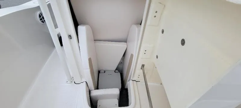 Slide: The Image of 2021 Robalo R200 boat interior storage compartment with white seating and clean design. - 25