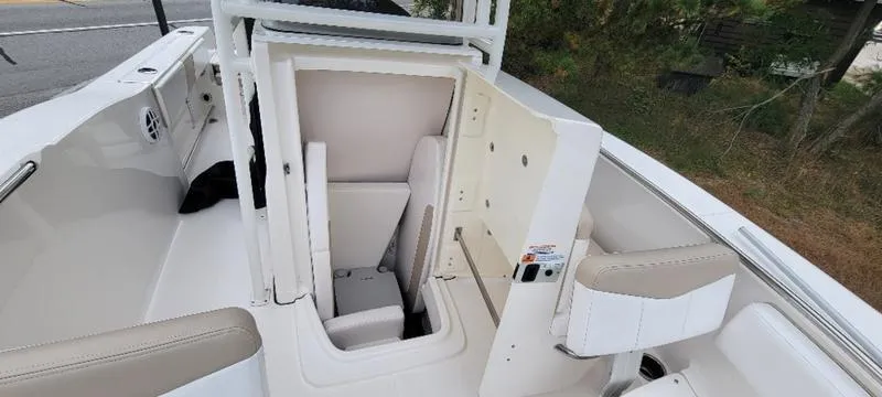 Slide: The Image of 2021 Robalo R200 boat interior with open storage compartment and seating. - 26