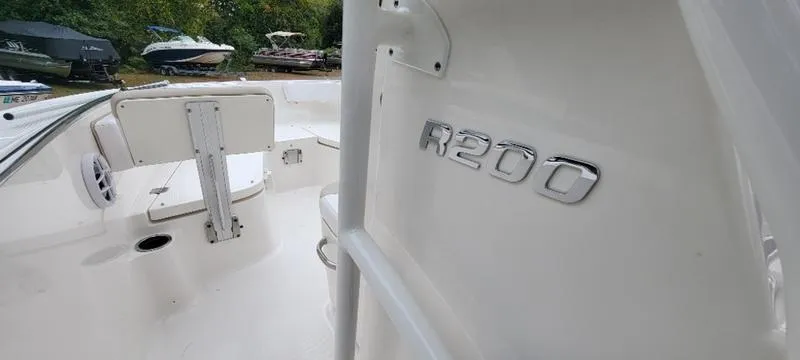 Slide: The Image of 2021 Robalo R200 boat interior with sleek white design and R200 emblem. - 3