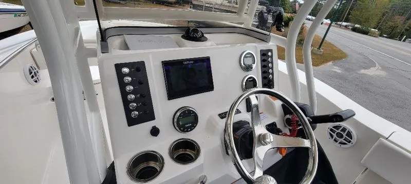 Slide: The Image of 2021 Robalo R200 boat dashboard with steering wheel and control panel. - 4