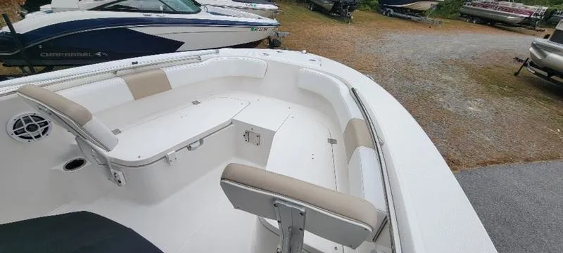 Slide: The Image of 2021 Robalo R200 boat interior with cushioned seating and storage compartments. - 7