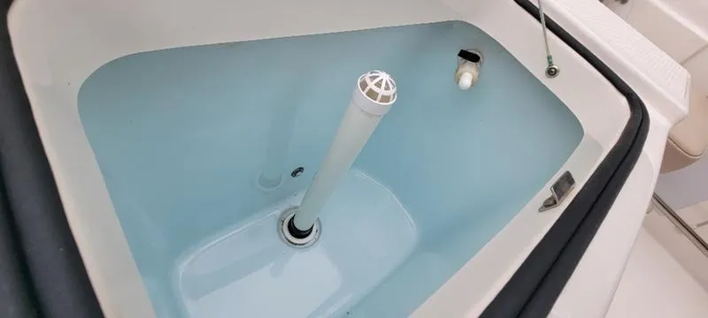 Slide: The Image of Livewell in 2021 Robalo R200 boat, featuring clean interior and drain system. - 8