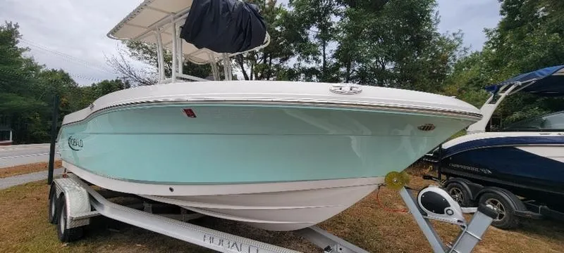Slide: The Image of 2021 Robalo R200 boat on trailer, light blue hull, parked outdoors. - 9