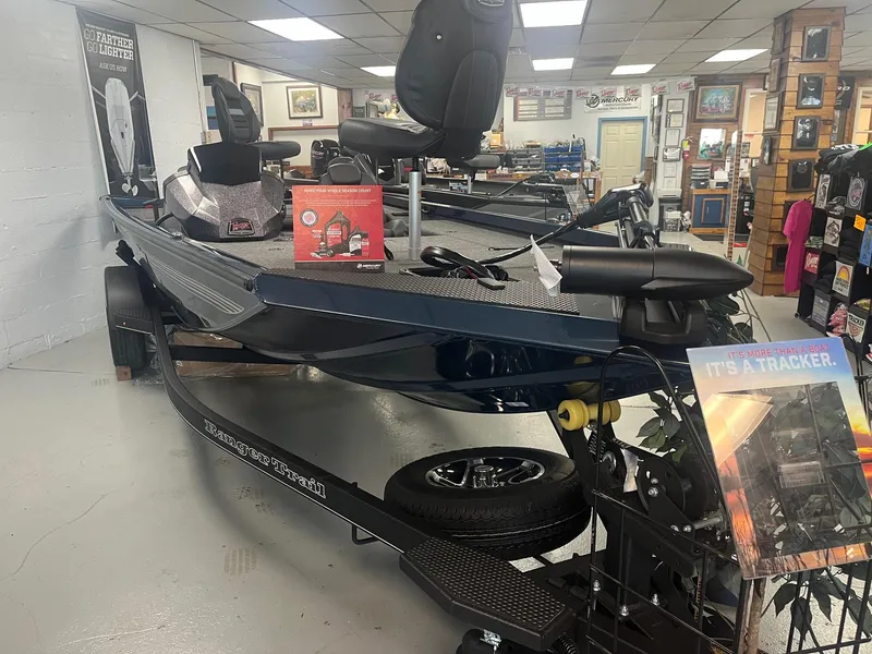 Slide: The Image of 2025 Ranger RT178 boat displayed indoors with promotional materials. - 1