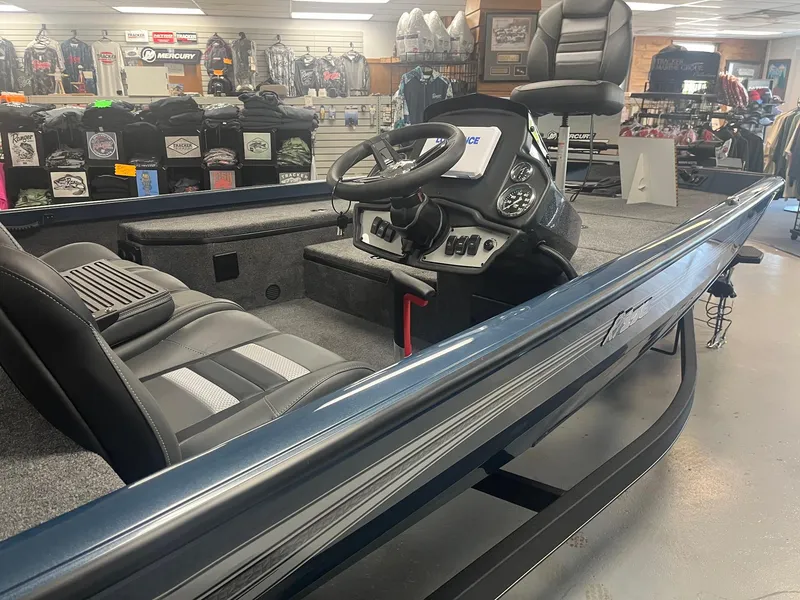Slide: The Image of 2025 Ranger RT178 boat interior with steering console in showroom. - 2