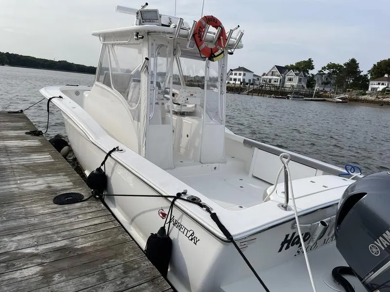 Slide: The Image of 2016 Jarrett Bay 32 Walk Around boat docked by waterfront homes. - 11