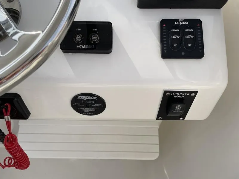 Slide: The Image of Close-up of 2016 Jarrett Bay 32 WALK AROUND boat controls and steering wheel. - 13