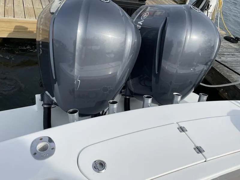 Slide: The Image of 2016 Jarrett Bay 32 Walk Around boat with dual outboard engines at dock. - 14