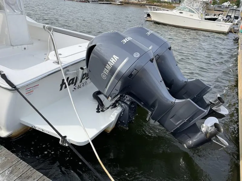 Slide: The Image of 2016 Jarrett Bay 32 Walk Around with twin Yamaha 300 engines docked by the water. - 15