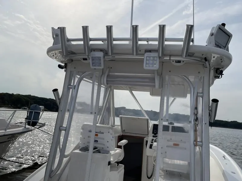 Slide: The Image of 2016 Jarrett Bay 32 Walk Around boat with fishing rod holders and navigation equipment. - 16