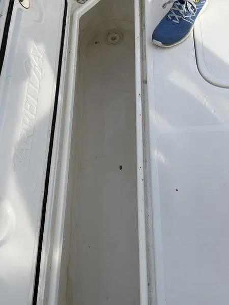 Slide: The Image of 2016 Jarrett Bay 32 Walk Around boat storage compartment with visible deck and shoe. - 23