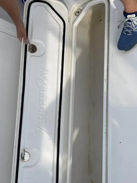 Slide: The Image of 2016 Jarrett Bay 32 Walk Around boat storage compartment with open hatch. - 24