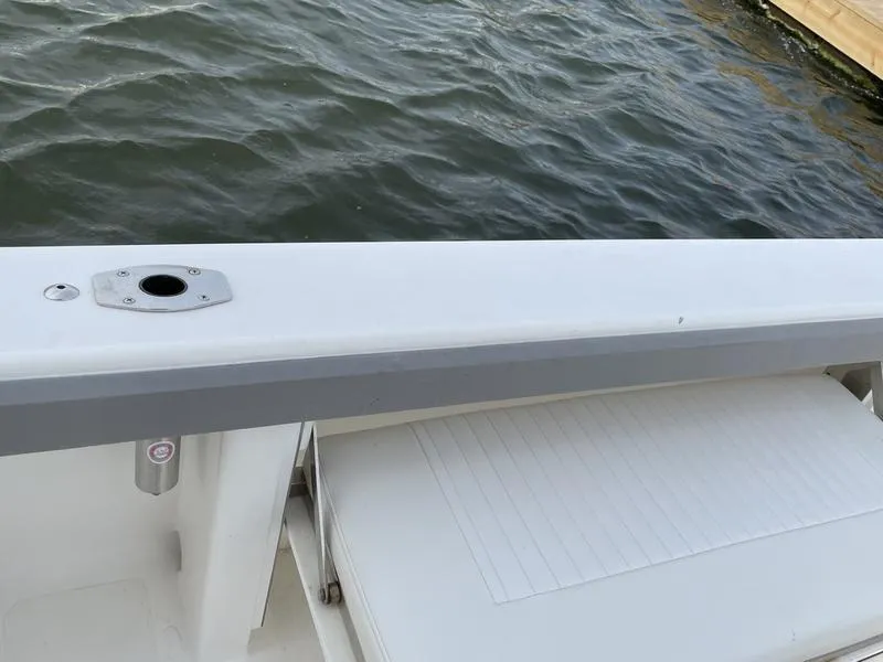 Slide: The Image of Jarrett Bay 32 Walk Around 2016 boat deck by the water. - 26