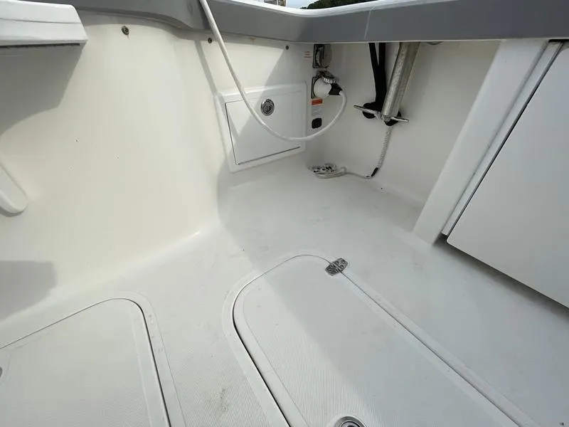 Slide: The Image of 2016 Jarrett Bay 32 Walk Around boat interior, featuring clean white deck and storage compartments. - 3