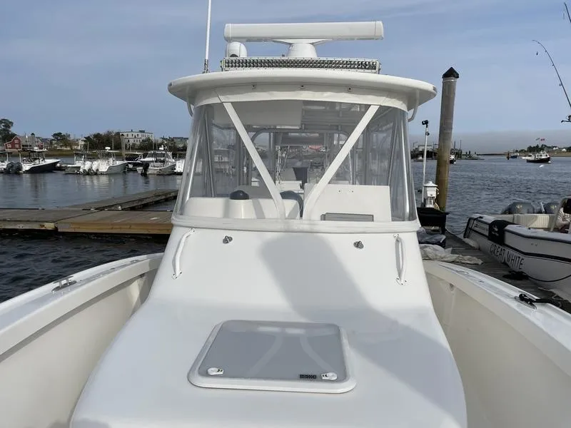 Slide: The Image of 2016 Jarrett Bay 32 Walk Around boat docked at marina. - 30