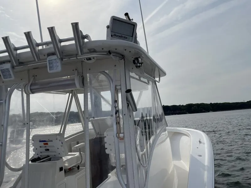 Slide: The Image of 2016 Jarrett Bay 32 Walk Around boat on calm water, featuring sleek design and advanced equipment. - 31