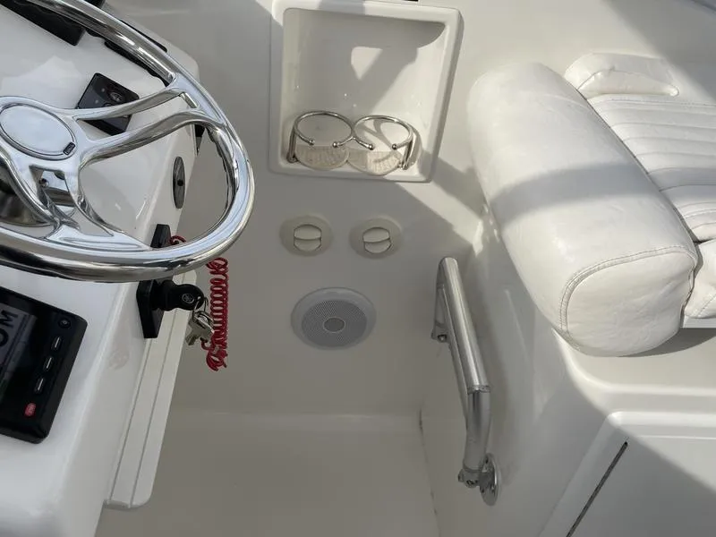 Slide: The Image of 2016 Jarrett Bay 32 Walk Around helm with steering wheel and white seating. - 35