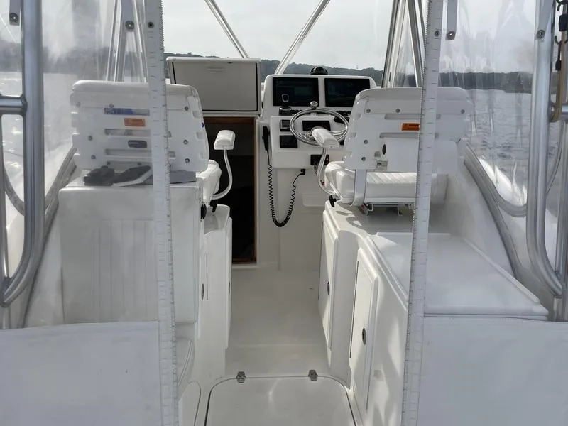 Slide: The Image of 2016 Jarrett Bay 32 Walk Around boat interior with helm and seating. - 36