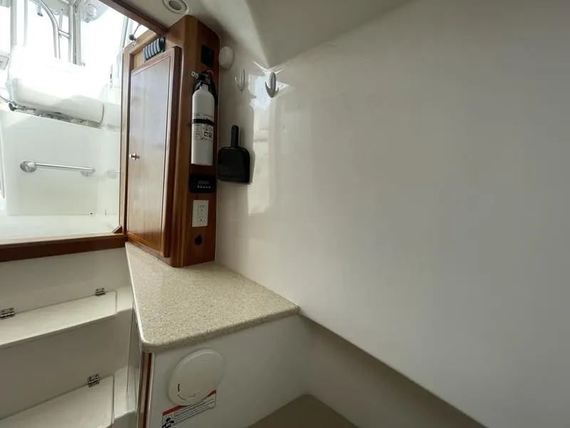 Slide: The Image of 2016 Jarrett Bay 32 Walk Around cabin interior with storage and fire extinguisher. - 37