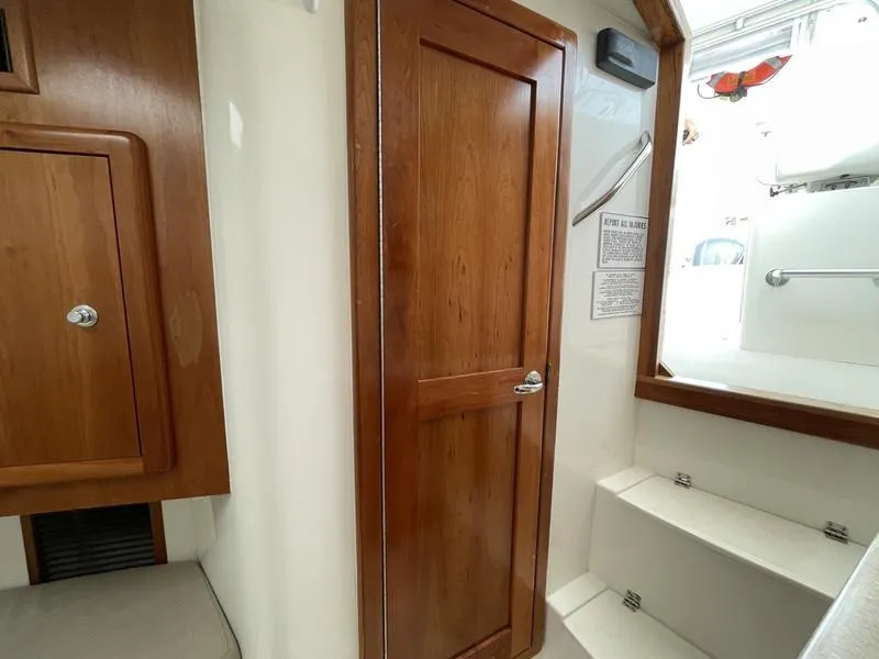 Slide: The Image of 2016 Jarrett Bay 32 Walk Around interior with wooden door and steps. - 38