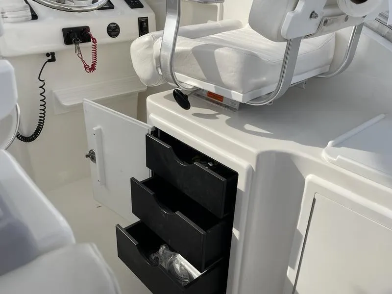 Slide: The Image of 2016 Jarrett Bay 32 Walk Around boat interior with open storage drawers. - 39
