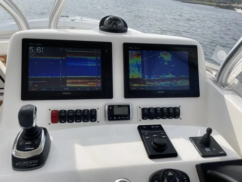 Slide: The Image of Control panel of 2016 Jarrett Bay 32 Walk Around boat with navigation screens. - 5