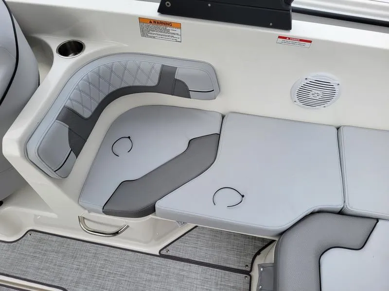 Slide: The Image of 2025 Bayliner VR6 OB boat interior seating with cup holders and speaker. - 14