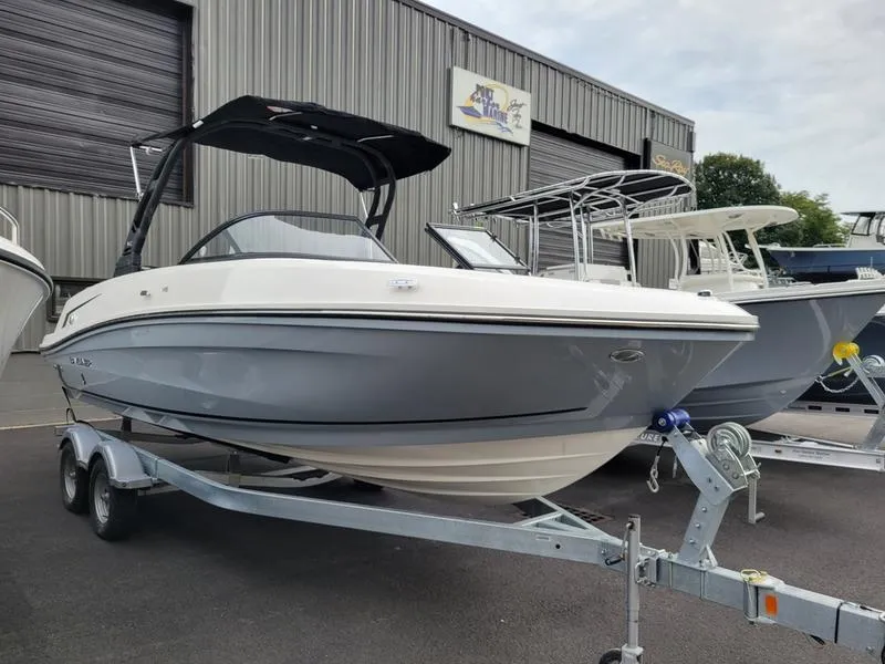 Slide: The Image of 2025 Bayliner VR6 OB boat on trailer, parked outside a warehouse. - 4