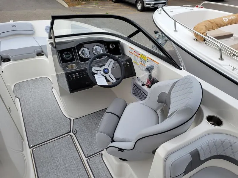 Slide: The Image of 2025 Bayliner VR6 OB boat cockpit with modern steering and comfortable seating. - 5