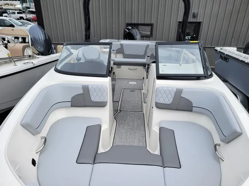 Slide: The Image of 2025 Bayliner VR6 OB boat interior with gray seating and open deck layout. - 7