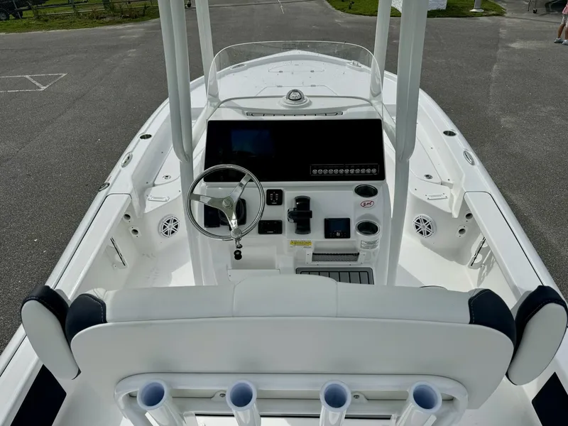Slide: The Image of 2025 Tidewater 2210 Carolina Bay boat interior with steering console and seating. - 5