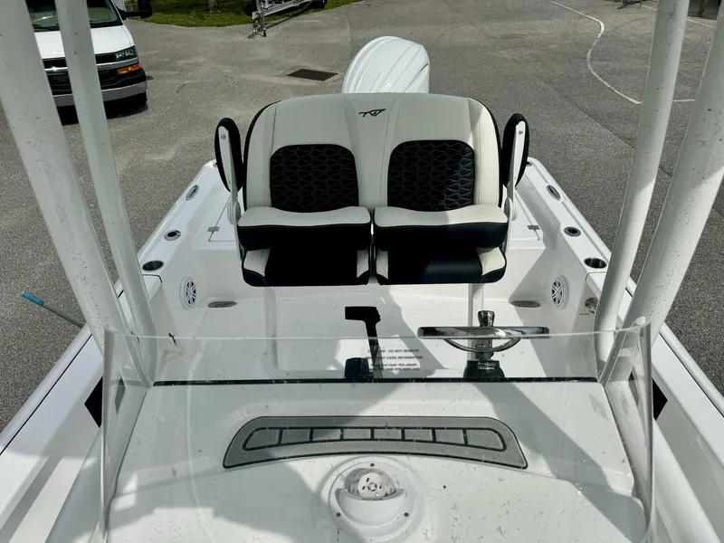 Slide: The Image of 2025 Tidewater 2210 Carolina Bay boat interior with dual seats and steering console. - 7