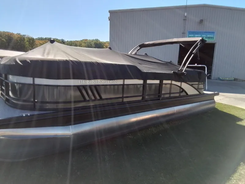 Slide: The Image of 2021 Bennington Marine 24 LXSR pontoon boat with cover, parked outdoors. - 13