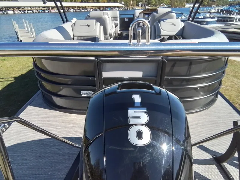 Slide: The Image of 2021 Bennington Marine 24 LXSR pontoon boat with 150 horsepower engine docked by the lake. - 14