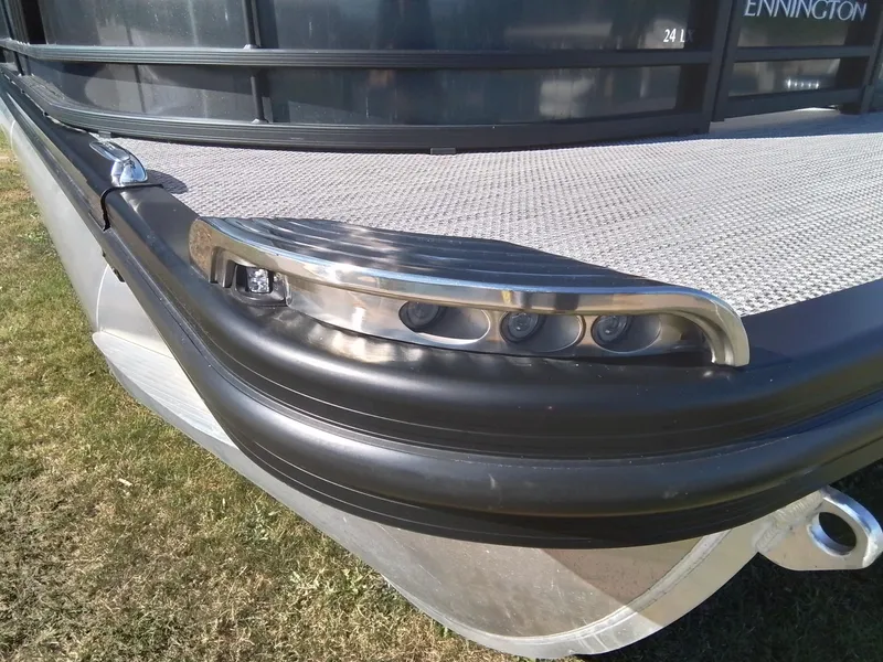 Slide: The Image of 2021 Bennington Marine 24 LXSR pontoon boat detail, featuring sleek design and modern lighting. - 16