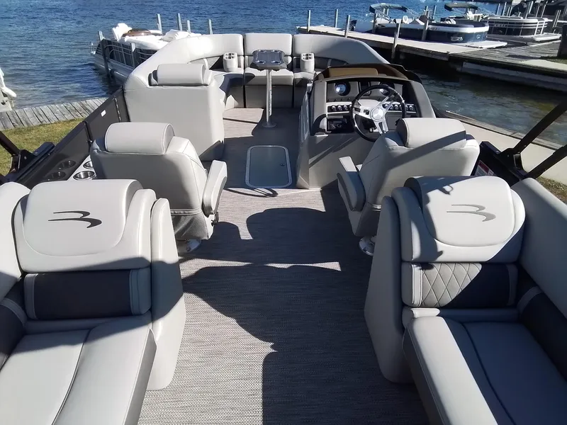 Slide: The Image of 2021 Bennington Marine 24 LXSR pontoon boat interior with luxurious seating and steering console. - 19
