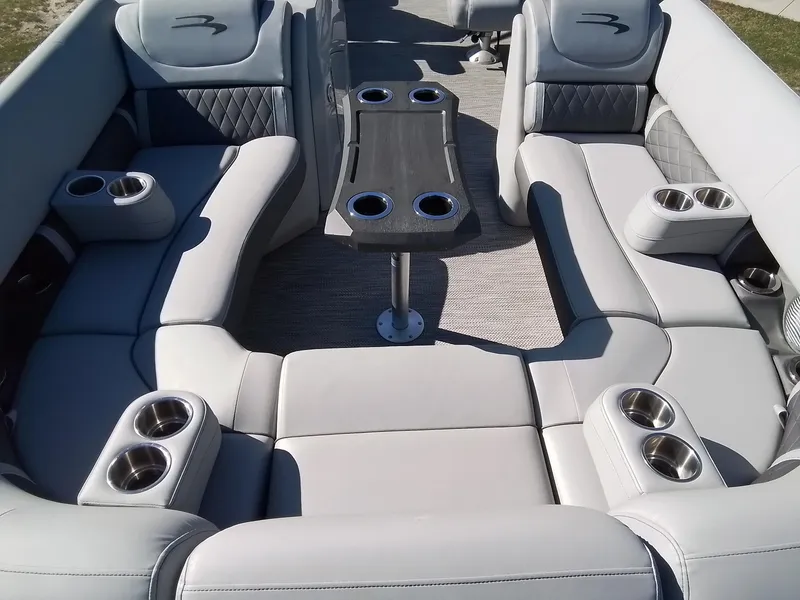 Slide: The Image of Luxurious seating area on a 2021 Bennington Marine 24 LXSR pontoon boat with cup holders. - 21