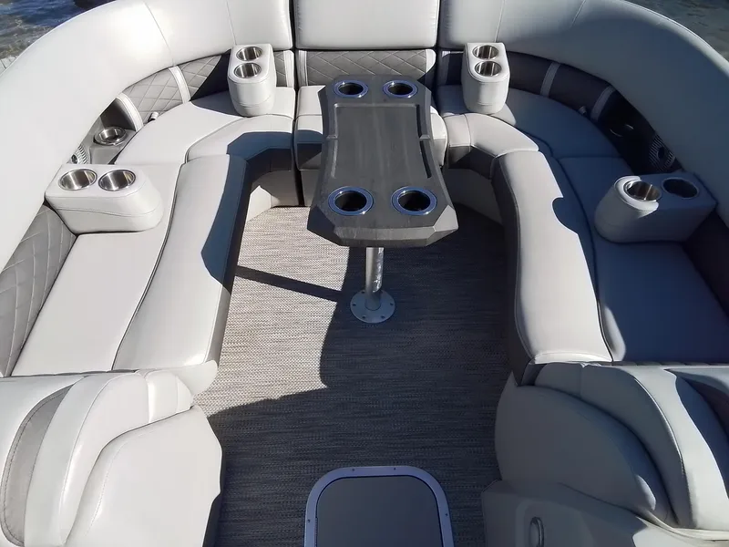 Slide: The Image of 2021 Bennington Marine 24 LXSR boat interior with plush seating and cup holders. - 22