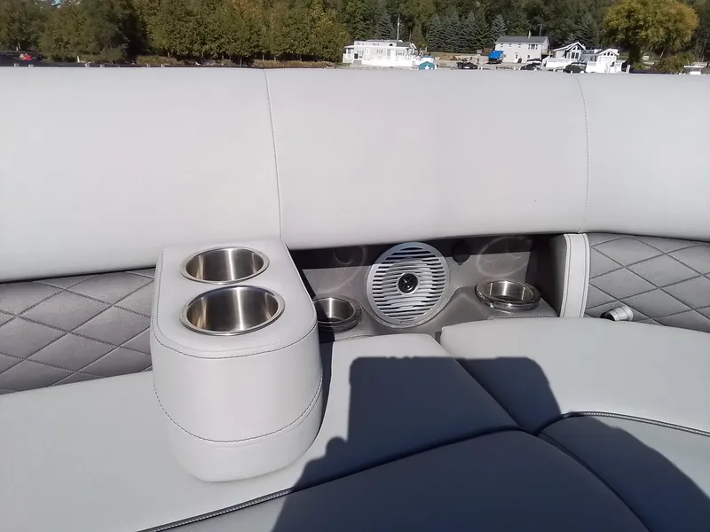 Slide: The Image of 2021 Bennington Marine 24 LXSR boat interior with cup holders and speaker. - 23